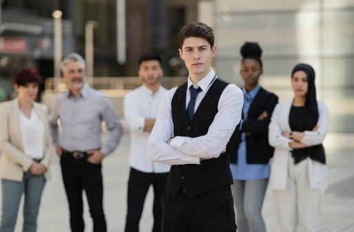 group of multiracial businesspeople standing,multiracial business people standing focus on young Caucasian man