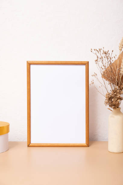 istock Mock up empty wooden frame mockup, dried grass and palm leaves on white background, interior, home design. Art concept. copy space 1411171603