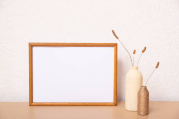 istock Mock up empty wooden frame mockup, dried grass in vase on white background, interior, home design. Art concept. copy space 1411171651