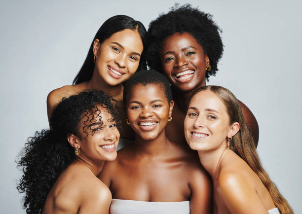 Beauty portrait of a diverse group of beautiful women smiling together against a grey studio background. Faces of female models with perfect, clear skin and complexion from a daily skincare routine Beauty portrait of a diverse group of beautiful women smiling together against a grey studio background. Faces of female models with perfect, clear skin and complexion from a daily skincare routine beautiful black woman stock pictures, royalty-free photos & images
