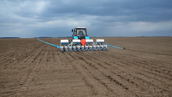 Chortkiv - Ternopil - Ukraine - April 1, 2014. With the use of a precision seed drill, mineral fertilizers are sown and early crops are sown