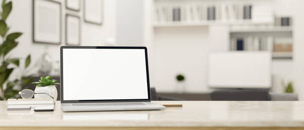 istock White workspace tabletop with notebook laptop and copy space over blurred office in the background 1411181013