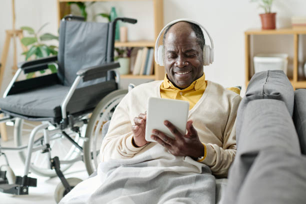 istock Man listening to music on tablet pc 1411181176