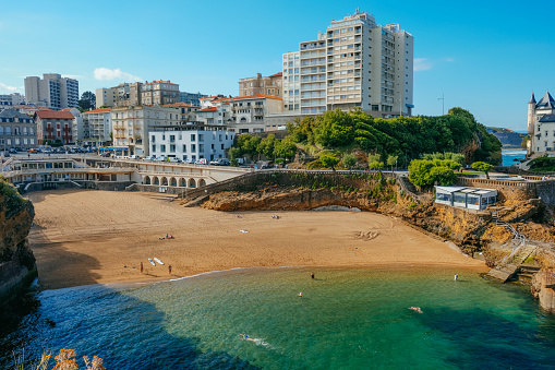 Biarritz, France - June 24, 2022: A view over the Plage du Port Vieux beach in Biarritz, France, with some people enjoying the beach