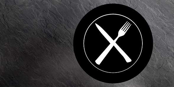 Topview of Set of Plate, Fork and Knife Silhouette on Dark Gray Background