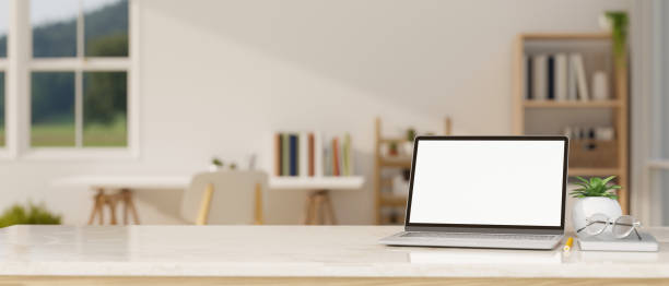 istock White tabletop with laptop mockup and montage space over blurred minimal home working room 1411182474