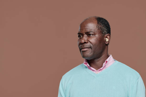 Senior African man with hearing aid