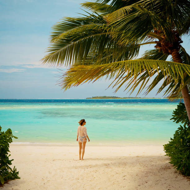 Woman enjoying ocean at the tropical beach stock photo
