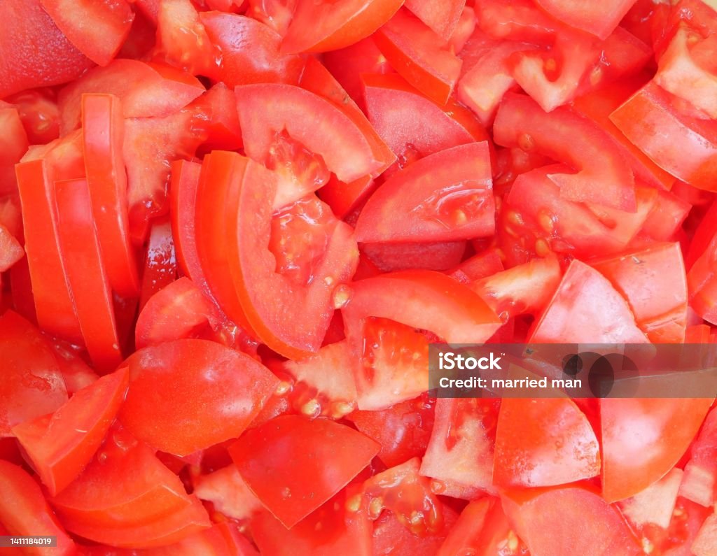 Large red delicious tomatoes sliced for salad. Vitamin food for vegetarians, ready to eat. Ripe fragrant vegetables without spices. Vitamin food for vegetarians, ready to eat. Large red delicious tomatoes sliced for salad. Ripe fragrant vegetables without spices. Tomato Stock Photo