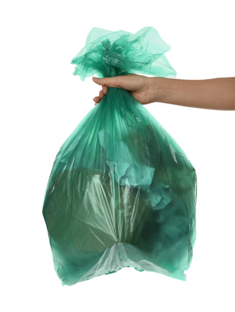 istock Woman holding trash bag filled with garbage on white background, closeup 1411184779