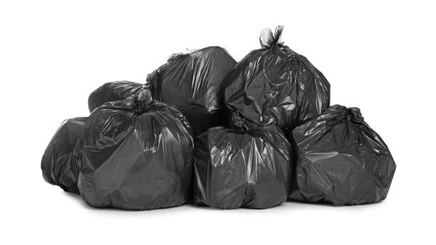 istock Black trash bags filled with garbage on white background 1411184843