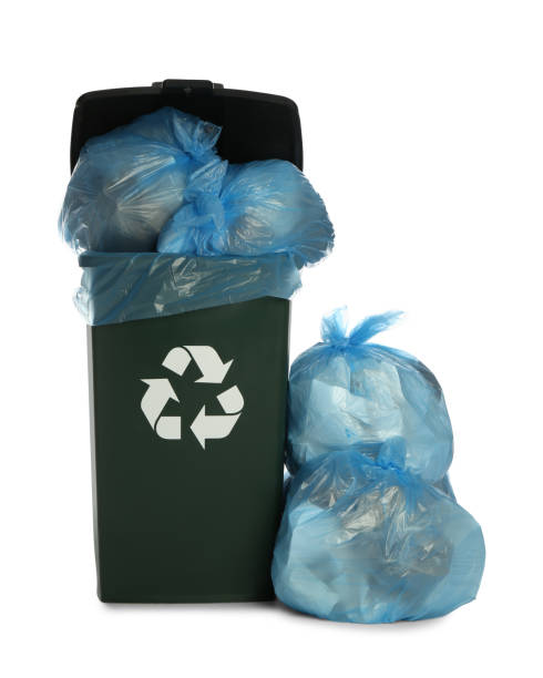 istock Dark green recycling bin overfilled with garbage bags on white background 1411184870