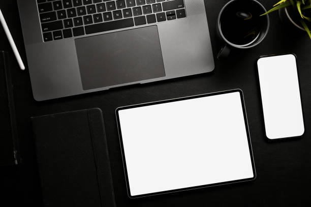 istock Modern black office desk workspace with laptop, smartphone and digital tablet mockup. top 1411184937