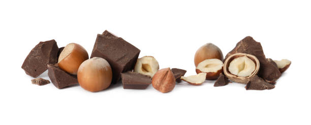 istock Delicious chocolate chunks and hazelnuts on white background 1411185200