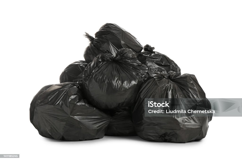 Black trash bags filled with garbage on white background Garbage Bag Stock Photo