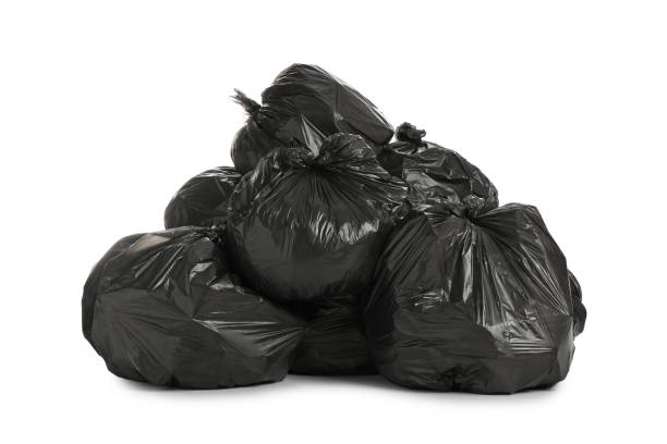 Black trash bags filled with garbage on white background Black trash bags filled with garbage on white background garbage bag stock pictures, royalty-free photos & images