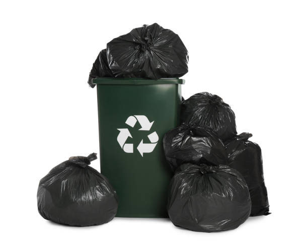 istock Dark green recycling bin overfilled with garbage bags on white background 1411187683