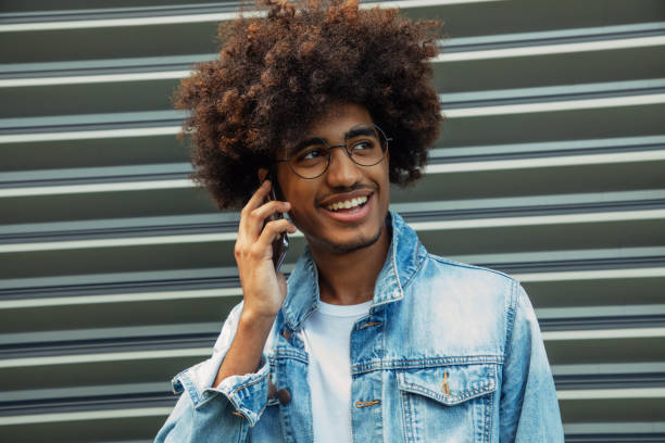 istock African american man with african hairstyle using phone 1411188231