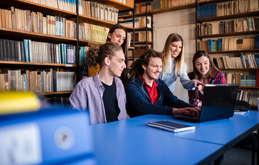 Students in the library look at the grade statistics