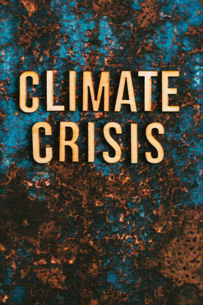 istock Wooden letters spelling words 'Climate Crisis' on textured background 1411189691