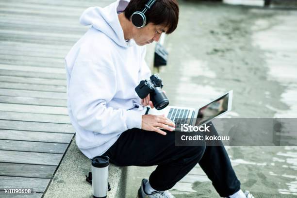 Male Video Creator Is Working At The Beach Stock Photo - Download Image Now - Japan, Photographer, Blogging
