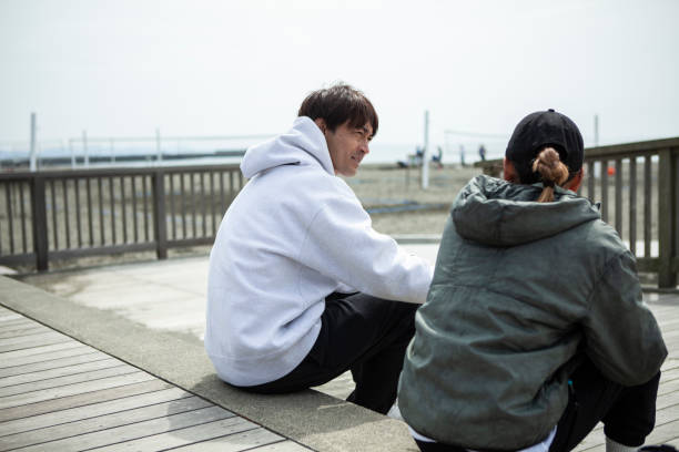 istock Young men and women talking on the beach terrace 1411190649
