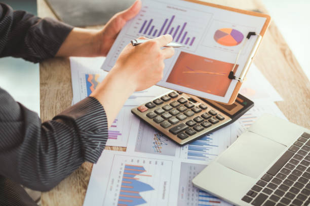 istock Professional business woman working with calculator, Doing finance on laptop, document graph and analysis business strategy to development profit. 1411191349
