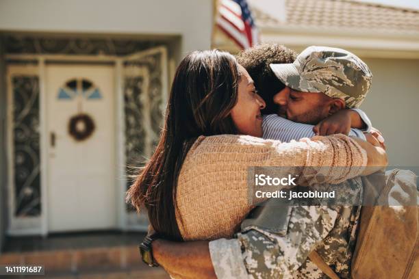 Military Serviceman Reuniting With His Family At Home Stock Photo - Download Image Now