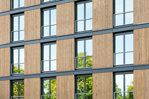 Apartment building with a wood facade.  Wood is a renewable and sustainable building material. Construction with wood can helps fight climate change and improves the quality of life of the residents.