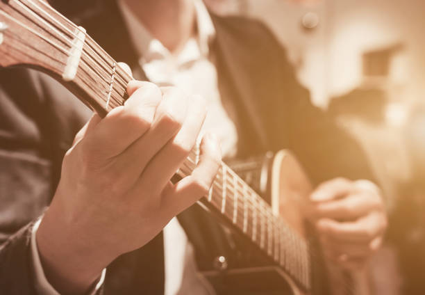 istock hands of a man playing the guitar 1411193692