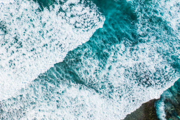 istock Big ocean waves hitting a coral reef. View from above. 1411194633