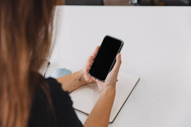 istock Woman using mobile phone in office. 1411196739
