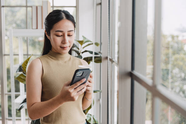 istock Woman using mobile phone in office. 1411196766