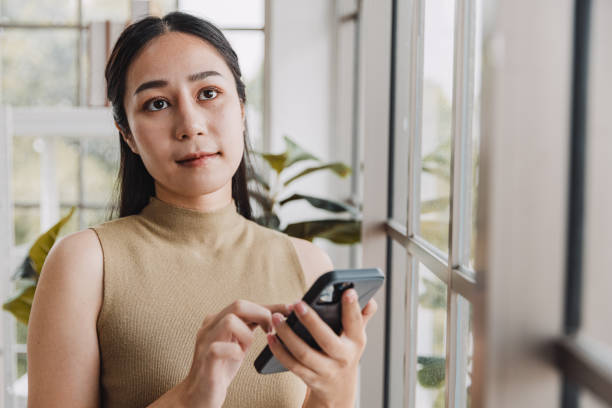 istock Woman using mobile phone in office. 1411196778