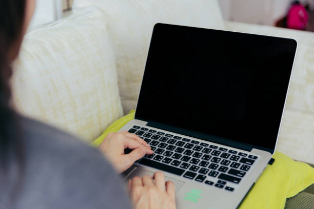 istock Woman using laptop at home. 1411197363