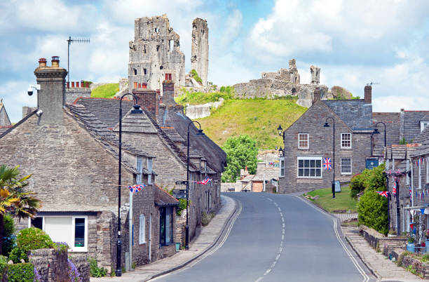Corfe Castle, empty streetscene, Dorset, England. Summer in Britain brings out the colours of the countryside and sunlight lifts the hues and shades of natural stone and architecture in the quaint and tranquil villages of England