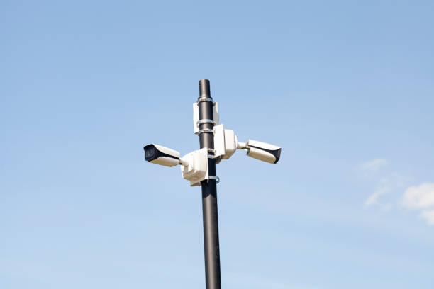 istock Surveillance Security Camera against the blue sky. 1411198830
