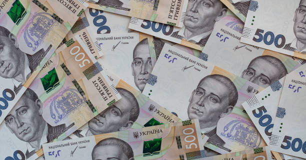 istock 100 dollar and  500 hryvnyas banknotes background 1411200586