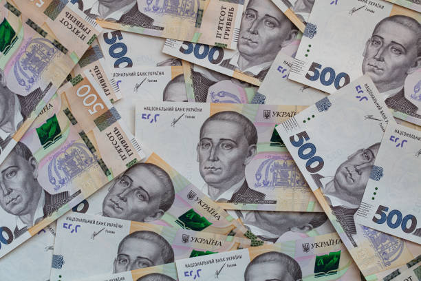 istock 100 dollar and  500 hryvnyas banknotes background 1411200589