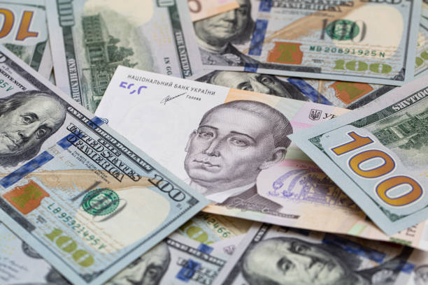 istock 100 dollar and  500 hryvnyas banknotes background 1411200977