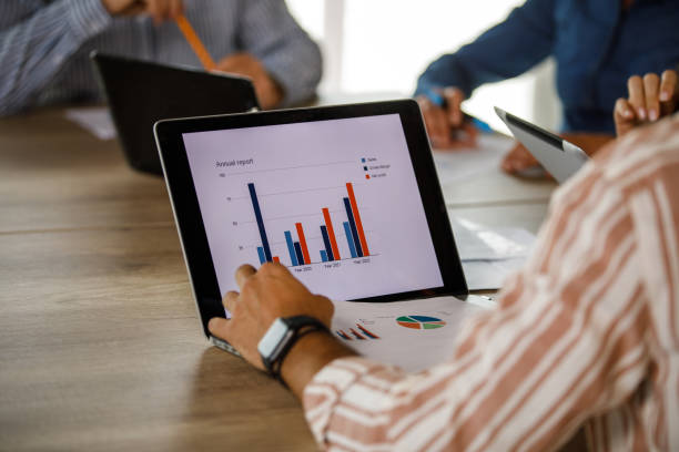 istock Businessman reviewing a document and data on laptop during a business meeting 1411201149