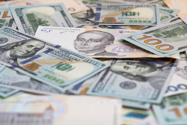 istock 100 dollar and  500 hryvnyas banknotes background 1411201239