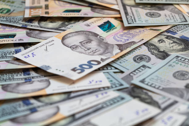 istock 100 dollar and  500 hryvnyas banknotes background 1411201955