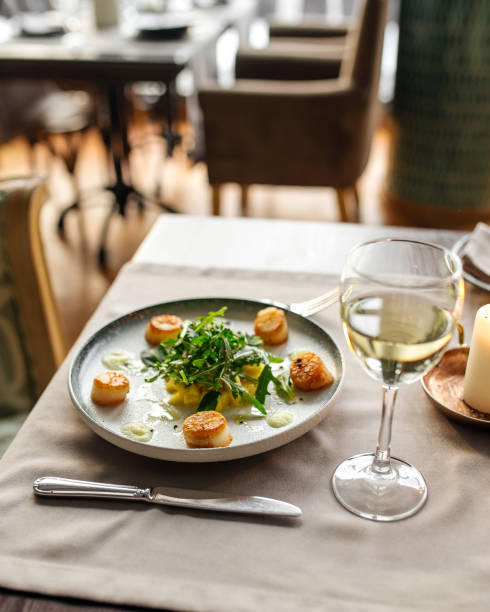 istock Gourmet cooked and garnished scallops on the table 1411202322