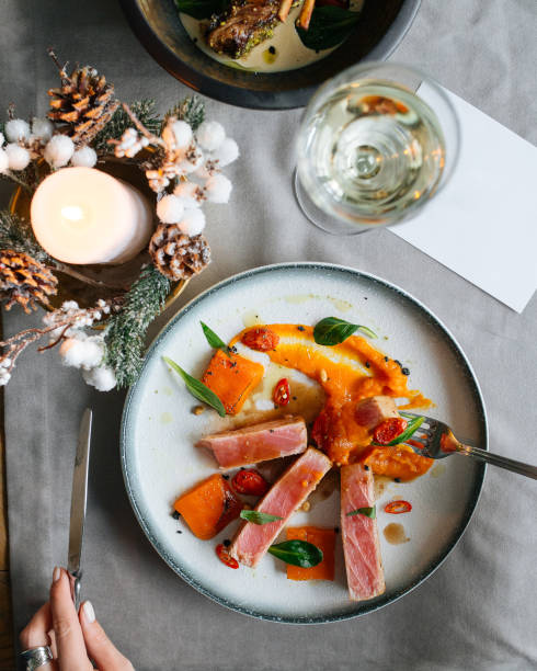 Top view on eating gourmet roasted tuna with pumpkin puree