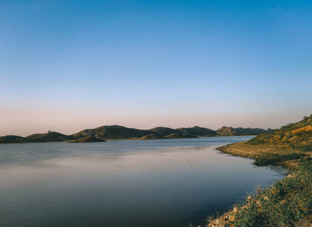 istock Scenic view of Lake with mountains 1411202503