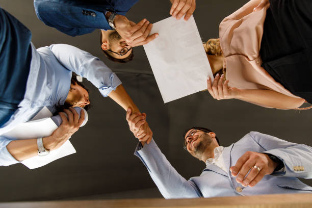 istock Two business people shaking hands when coming to agreement during a project meeting 1411204085