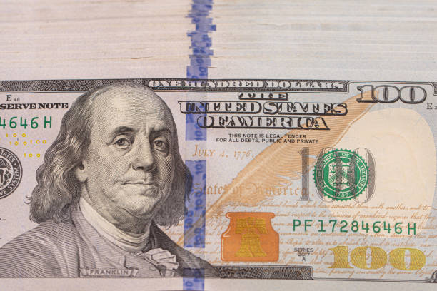 istock Pile of 100 dollar banknotes on white background 1411204359