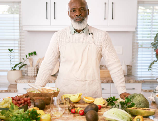 istock Portrait of a serious man standing in the kitchen 1411205427