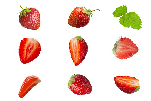 A set of whole and cut strawberries. Isolated on white background.